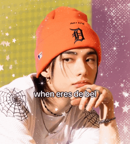 a young man wearing an orange beanie says when eres de bel