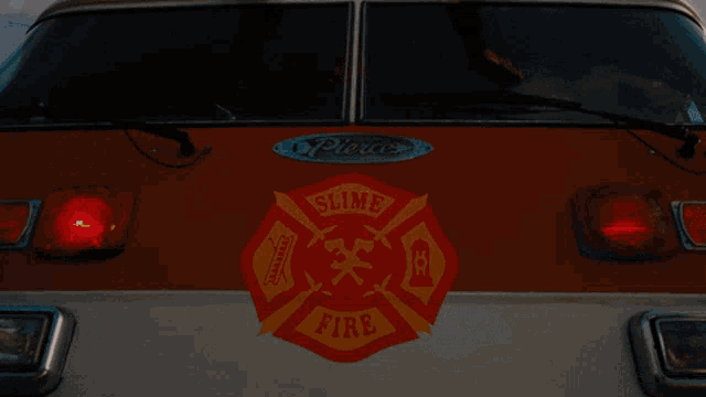 a man is sitting on top of a fire truck that says slime