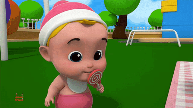 a baby in a pink outfit is eating a lollipop from a cartoon