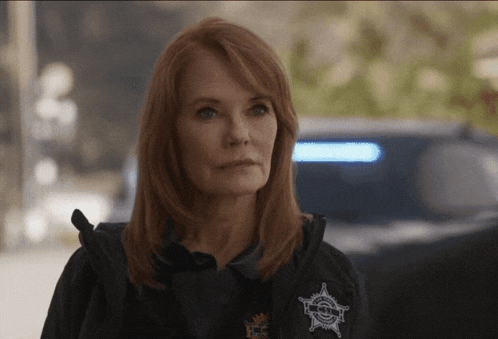 a woman wearing a vest that says sheriff 's office on it