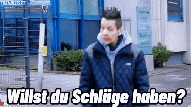 a man standing in front of a building with the words willst du schlage haben