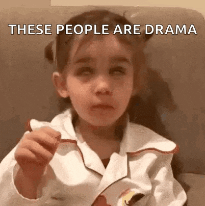 a little girl is sitting on a couch with her eyes closed and eating a candy bar .