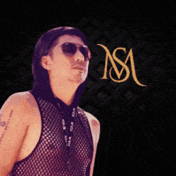 a man wearing sunglasses and a tank top with the letter nsm behind him