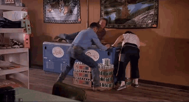 a group of people are standing around a pepsi box