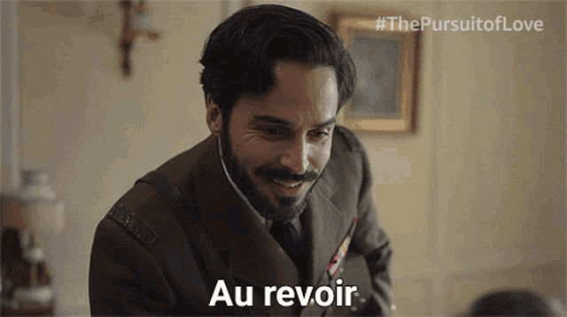 a man in a suit says au revoir in french