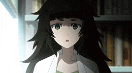 a girl with long black hair is standing in front of a bookshelf and looking at the camera .