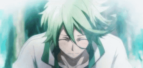 a close up of a person with green hair and a white shirt with their eyes closed .