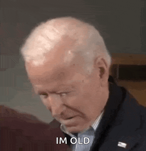 a man in a suit and tie is making a funny face and saying `` im old '' .