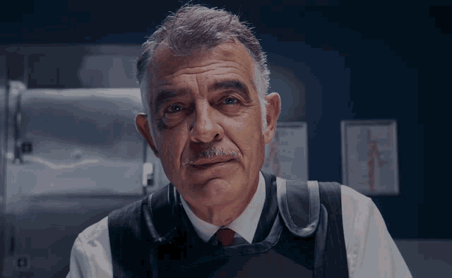 a man with a mustache is wearing a vest
