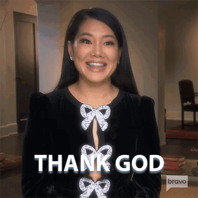 a woman in a black dress is smiling and says thank god