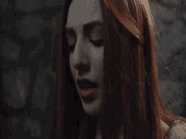 a close up of a woman with red hair