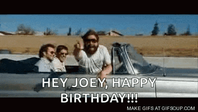 a group of men are driving a car and one of them is saying `` hey joey , happy birthday ! ''