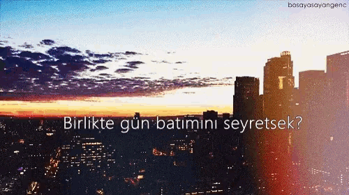a blurry picture of a city with the words birlikte gun batimini seyretsek