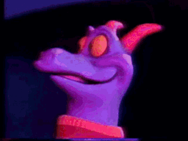 a purple cartoon character wearing a santa hat