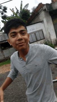 a young man wearing a grey shirt with the word eagle on the front