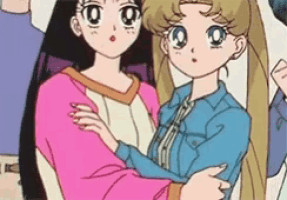two anime girls are standing next to each other in a group of people .