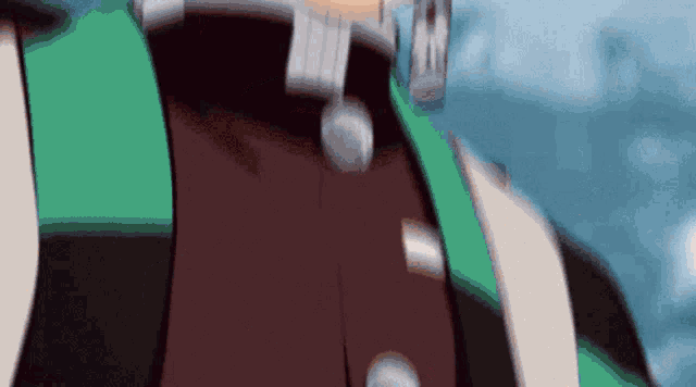 a close up of a person 's chest with a green and brown jacket and a necklace .