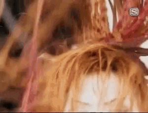 a close up of a person 's hair with a flower in it