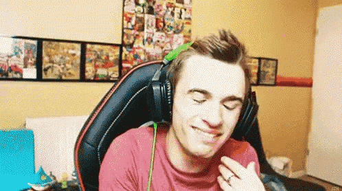 a man wearing headphones is sitting in a chair in a room .
