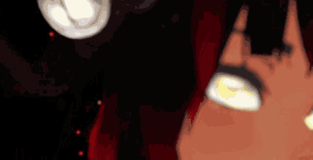 a close up of a person 's eyes with a black background
