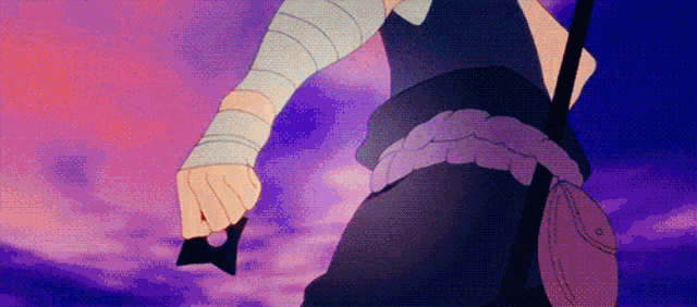 a person is holding a sword in their hand in front of a pink sky .