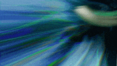 a blurry picture of a person 's face with a blue background