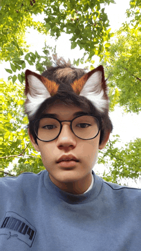 a young man wearing glasses and a puma shirt