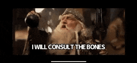 a man with a beard is talking to another man while holding a gun .