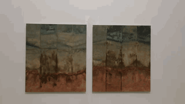two paintings are hanging on a white wall one of which has a brown border