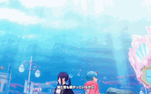 a couple of girls are standing in front of a large aquarium with bubbles coming out of the water