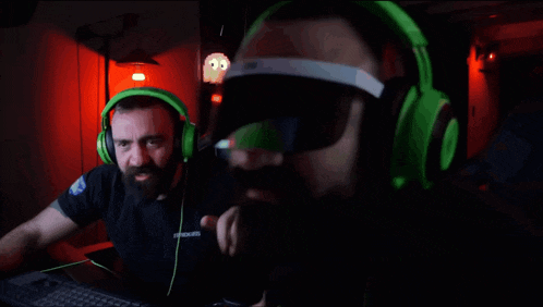 a man wearing green headphones and a black shirt that says ambush