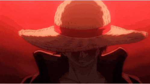 a man wearing a straw hat with a red ribbon around the brim