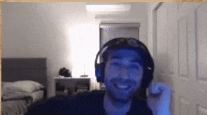 a man wearing headphones is smiling in a room