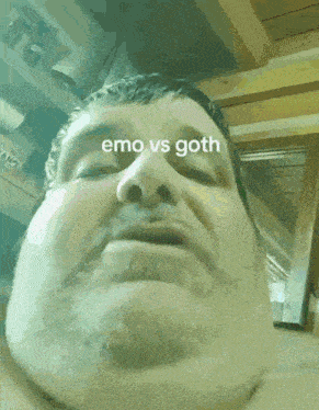 a close up of a man 's face with the words emo vs goth on the bottom