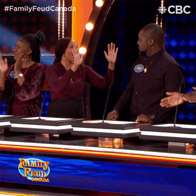 a group of people on a family feud game show