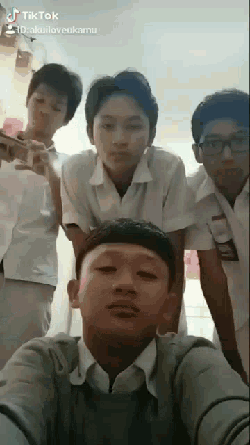 a group of young boys are posing for a picture with a tiktok hashtag