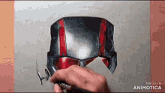 a person is drawing an ant man helmet with a pencil