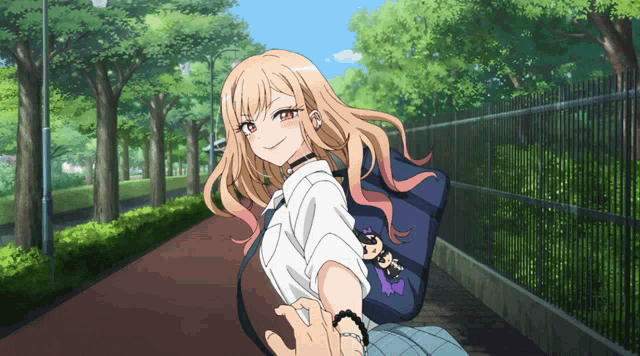 a girl walking down a sidewalk with a blue bag on her back that says ' aoi ' on it