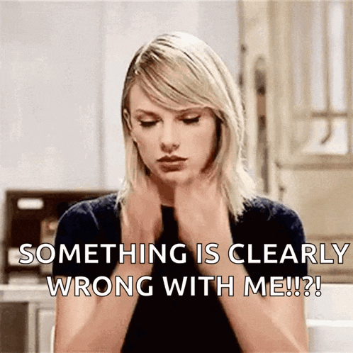 taylor swift is sitting in a kitchen with her hands on her neck and says something is clearly wrong with me !
