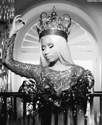 a woman is wearing a crown and smoking a cigarette in a black and white photo