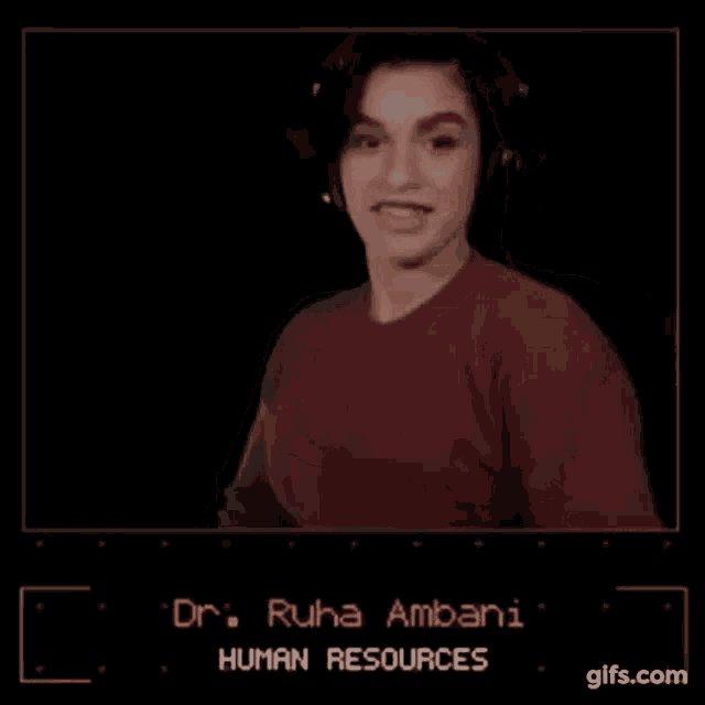a woman wearing headphones and a red sweater is standing in front of a black screen .