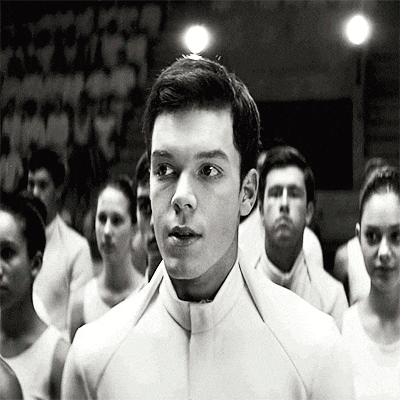 a man in a white uniform stands in front of a crowd