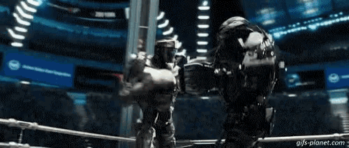 two robots are fighting each other in a boxing ring