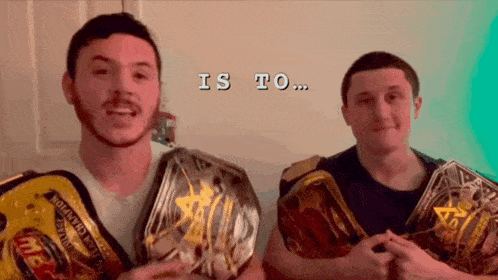two men holding wrestling belts with the words " is to " on the bottom