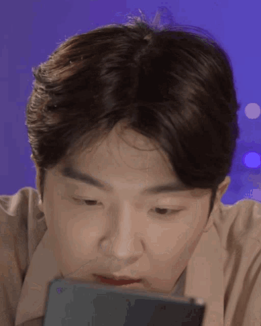 a close up of a man looking at a phone