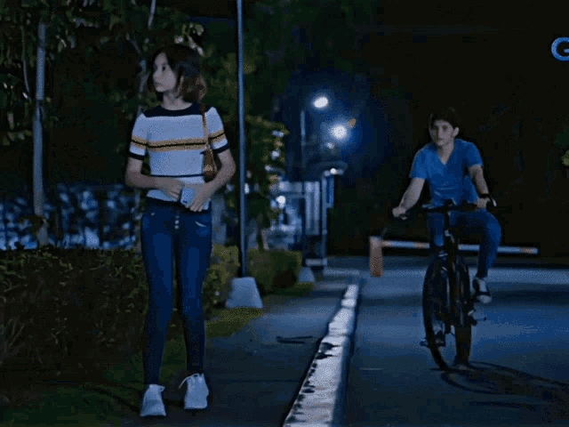 a man in a blue shirt is holding a rifle