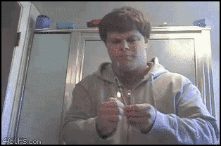 a man is lighting a light bulb with a 4gifs.com watermark on the bottom right