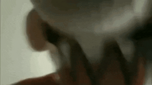 a close up of a person 's face with a blurred background .
