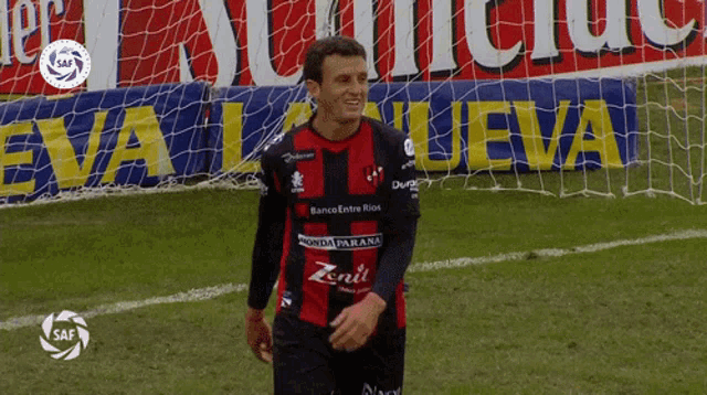 a soccer player wearing a shirt that says zenit stands on the field