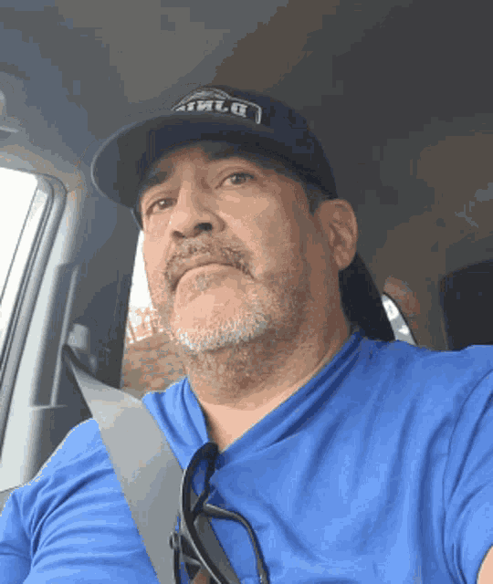 a man wearing a blue shirt and a hat that says athlr